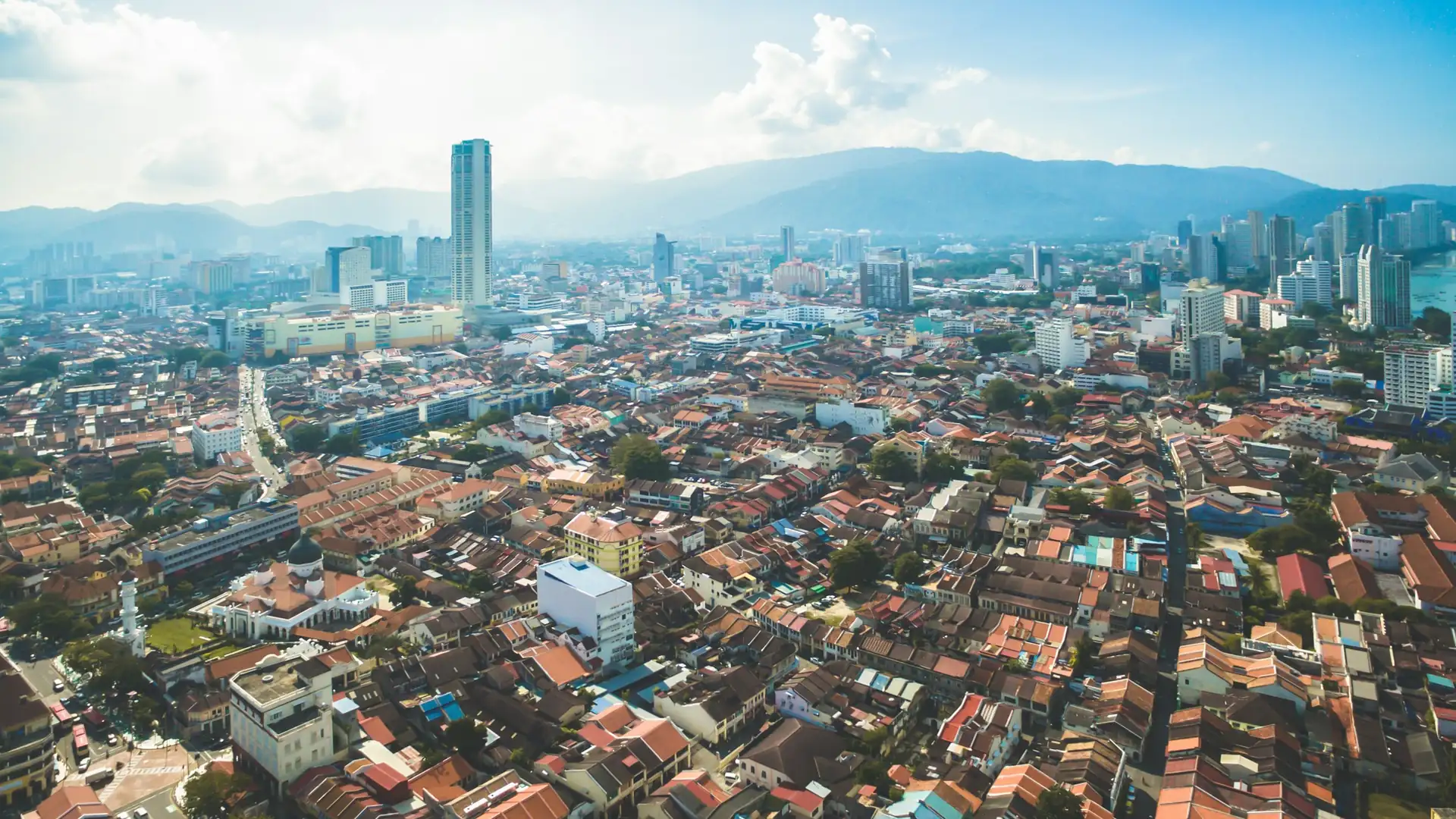 Aerial view of George Town, Penang, with the Komtar tower and heritage shophouse rooftops
